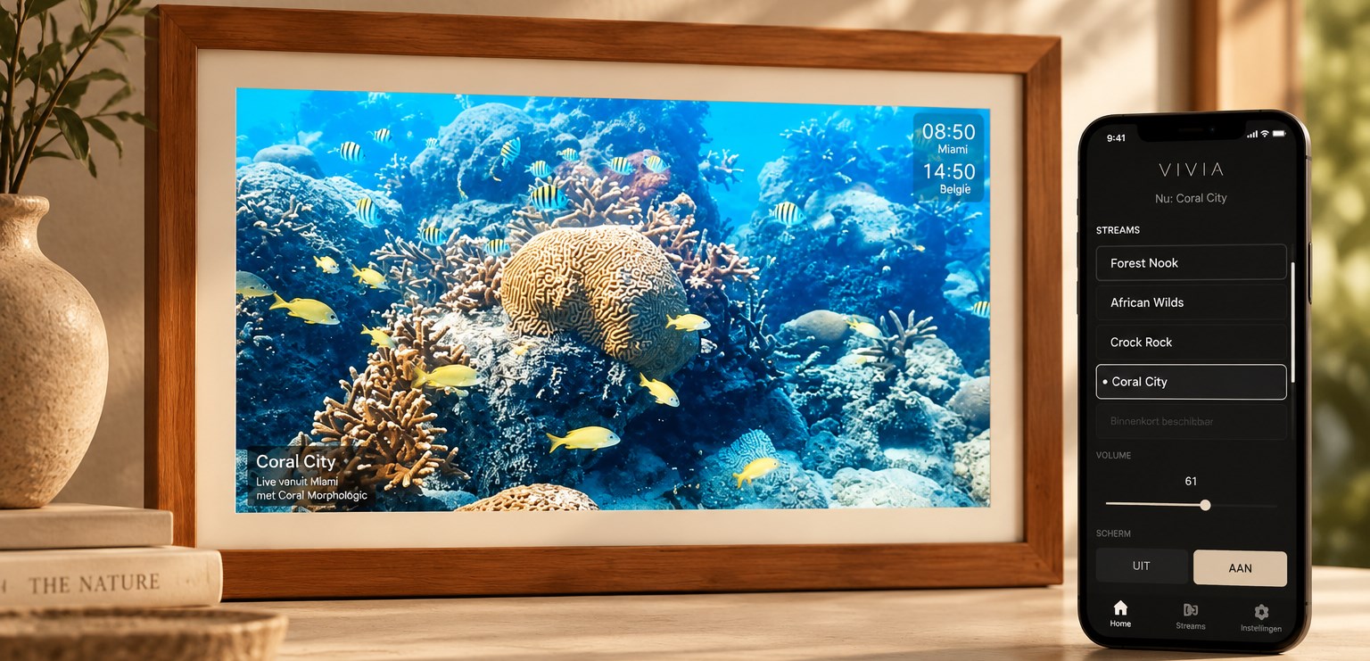 VIVIA wooden frame showing Coral City live, with the companion app open on a phone beside it
